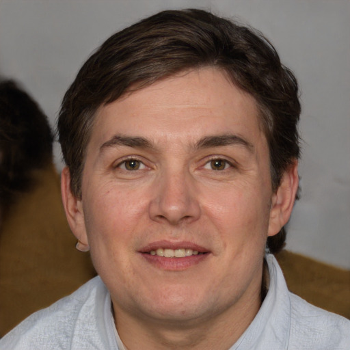 Joyful white adult male with short  brown hair and brown eyes