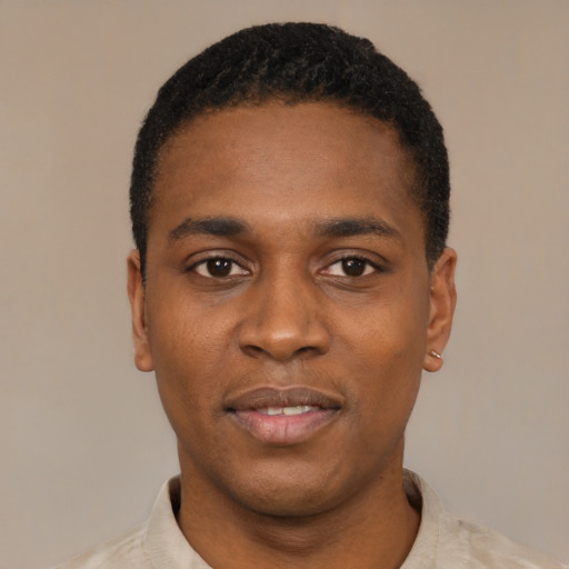 Joyful black young-adult male with short  black hair and brown eyes