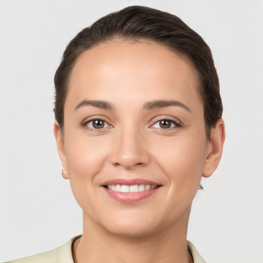 Joyful white young-adult female with short  brown hair and brown eyes