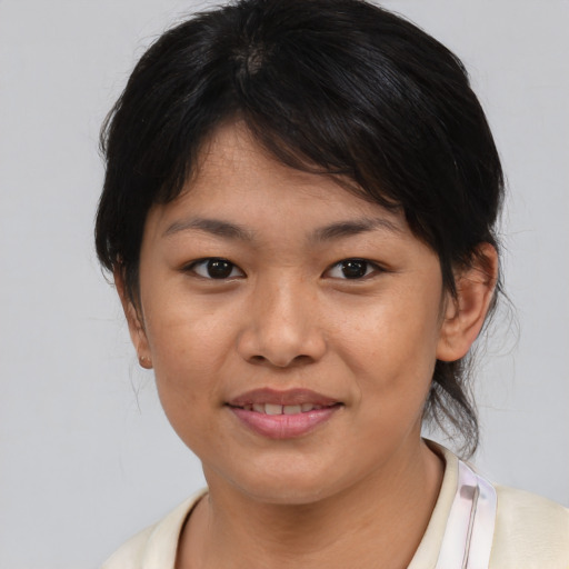 Joyful asian young-adult female with medium  brown hair and brown eyes