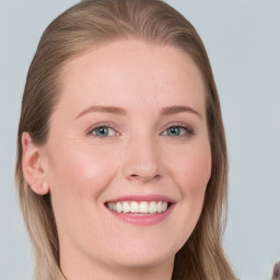 Joyful white young-adult female with long  brown hair and blue eyes