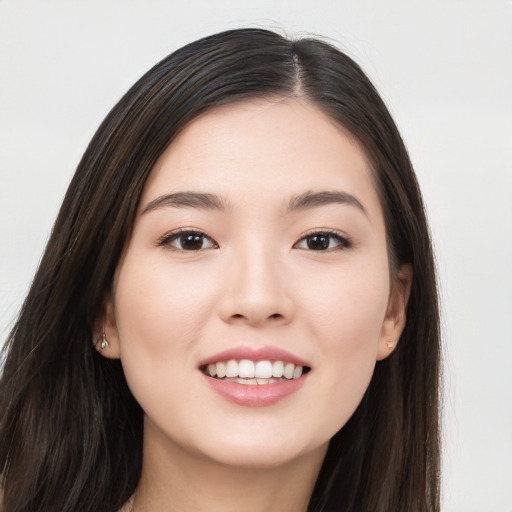 Joyful white young-adult female with long  black hair and brown eyes