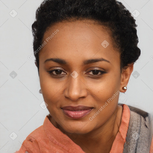 Joyful black young-adult female with short  black hair and brown eyes