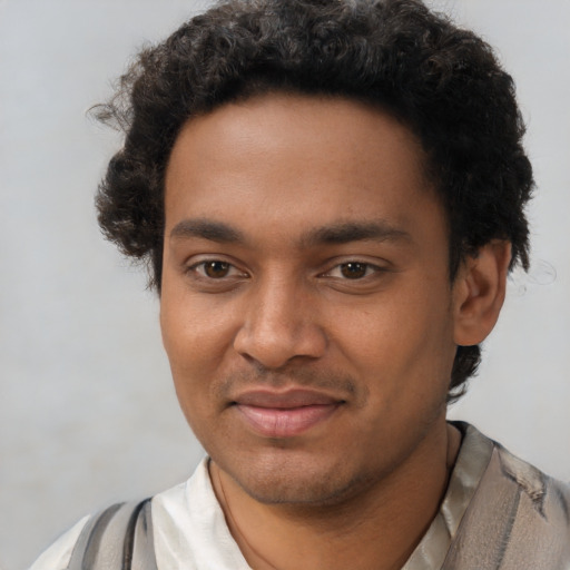 Joyful black young-adult male with short  black hair and brown eyes
