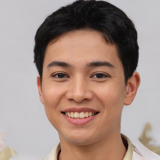 Joyful asian young-adult male with short  brown hair and brown eyes