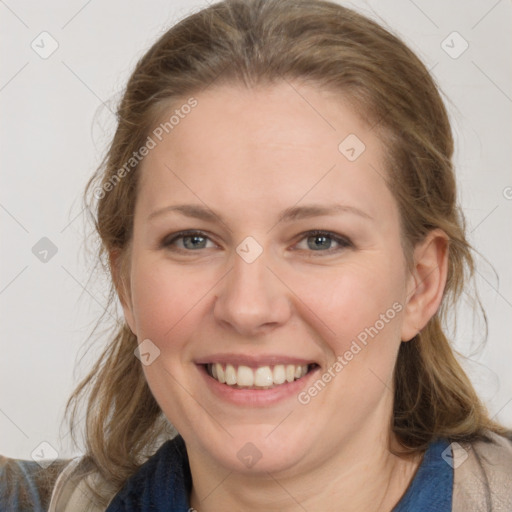 Joyful white young-adult female with medium  brown hair and blue eyes