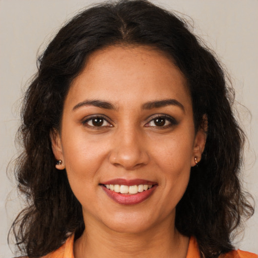 Joyful white young-adult female with long  brown hair and brown eyes
