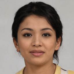 Joyful latino young-adult female with medium  brown hair and brown eyes