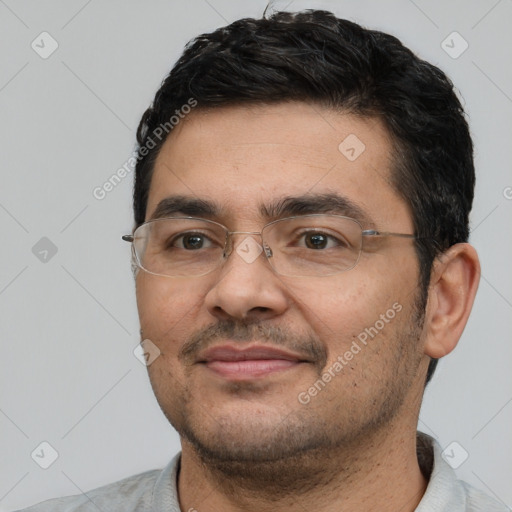 Joyful white adult male with short  black hair and brown eyes