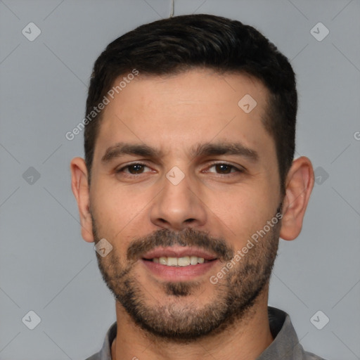 Joyful white young-adult male with short  black hair and brown eyes