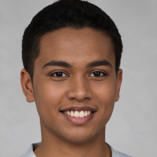 Joyful latino young-adult male with short  brown hair and brown eyes