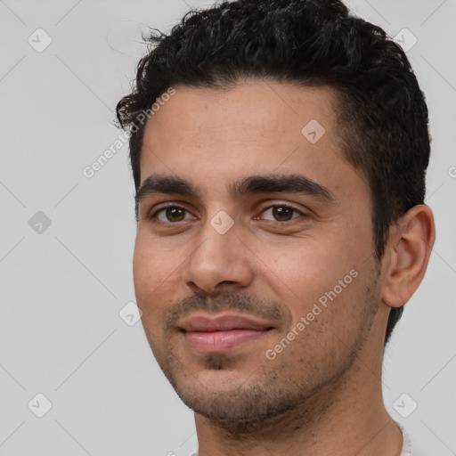 Joyful white young-adult male with short  black hair and brown eyes