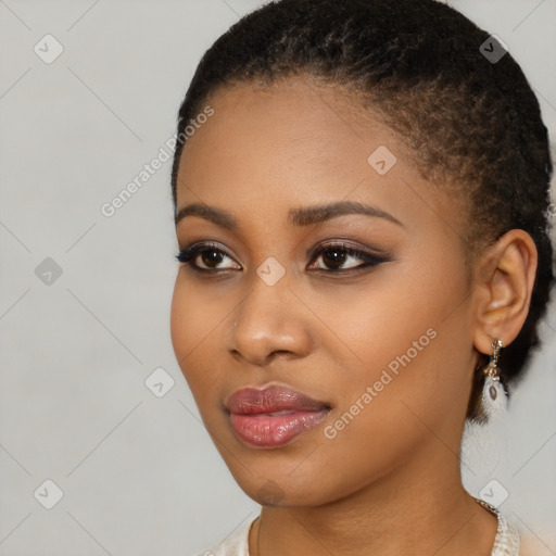 Joyful black young-adult female with short  black hair and brown eyes