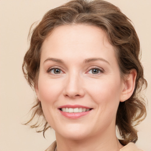 Joyful white young-adult female with medium  brown hair and grey eyes