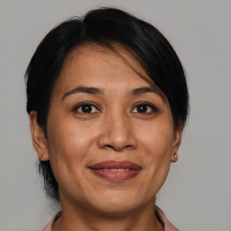 Joyful white adult female with medium  brown hair and brown eyes