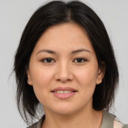 Joyful asian young-adult female with medium  brown hair and brown eyes