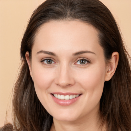 Joyful white young-adult female with long  brown hair and brown eyes