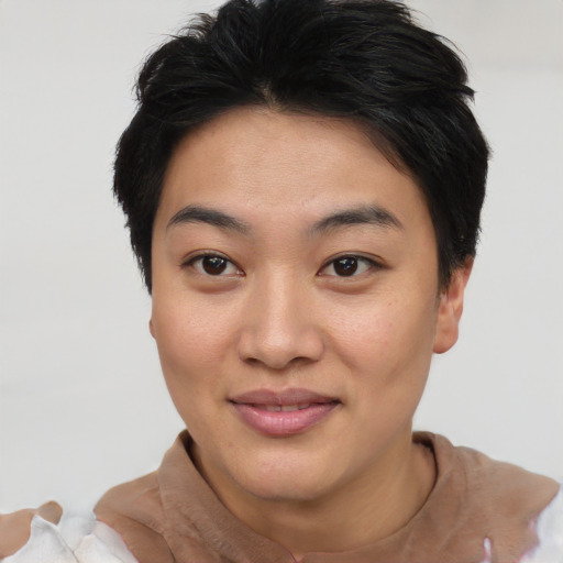 Joyful asian young-adult female with short  black hair and brown eyes