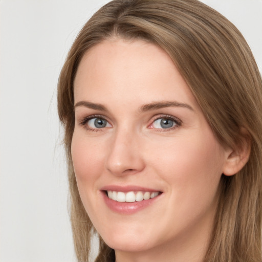 Joyful white young-adult female with long  brown hair and grey eyes