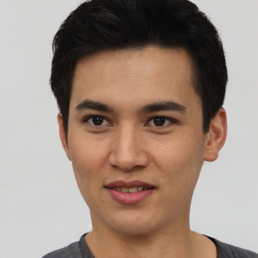 Joyful latino young-adult male with short  black hair and brown eyes