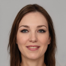 Joyful white young-adult female with long  brown hair and grey eyes