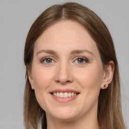 Joyful white young-adult female with long  brown hair and grey eyes