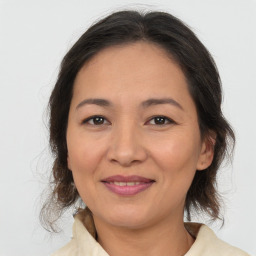 Joyful asian adult female with medium  brown hair and brown eyes