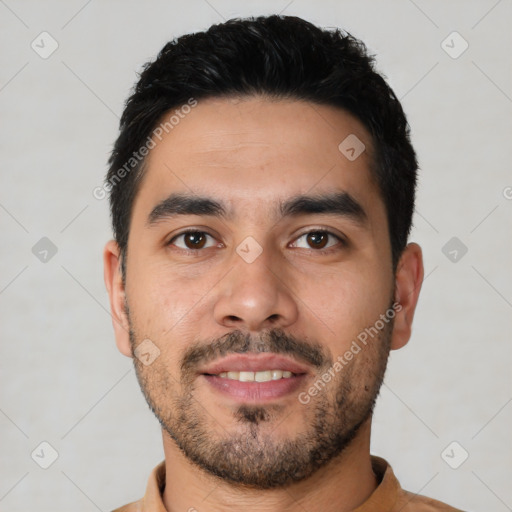 Joyful latino young-adult male with short  black hair and brown eyes