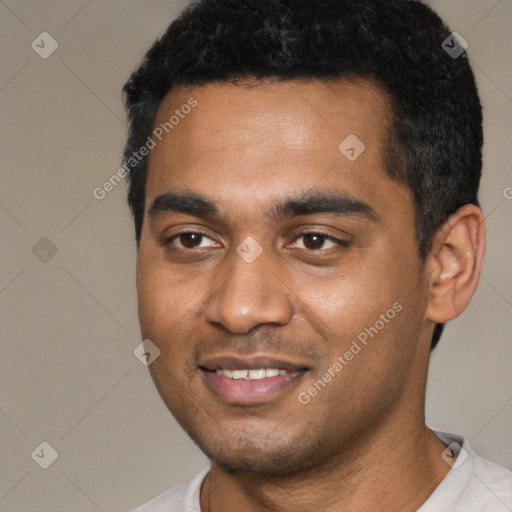 Joyful black young-adult male with short  black hair and brown eyes