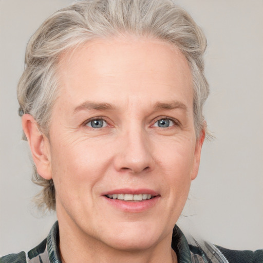 Joyful white adult female with medium  brown hair and blue eyes