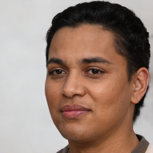 Joyful latino young-adult male with short  black hair and brown eyes