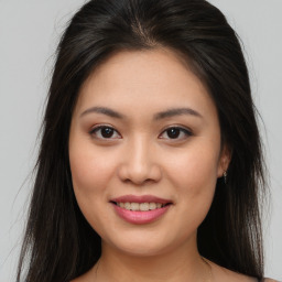 Joyful asian young-adult female with long  brown hair and brown eyes