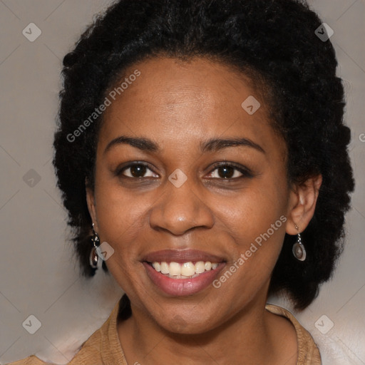 Joyful black adult female with long  brown hair and brown eyes