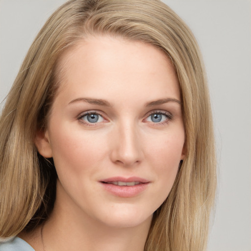 Joyful white young-adult female with long  brown hair and blue eyes