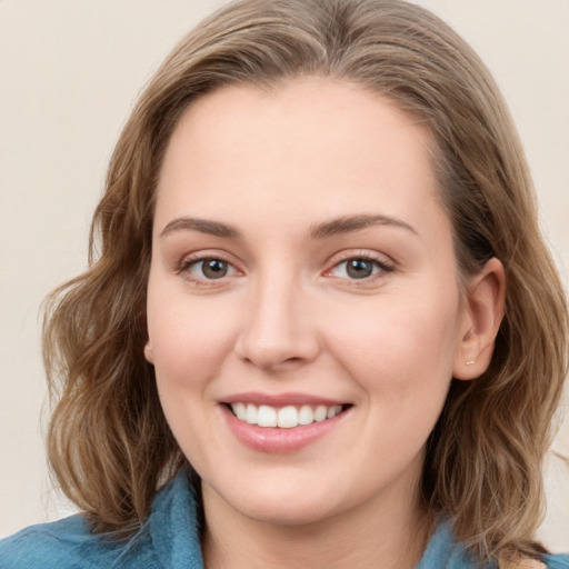 Joyful white young-adult female with medium  brown hair and blue eyes