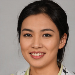 Joyful latino young-adult female with medium  brown hair and brown eyes