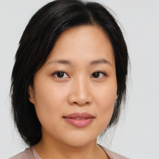 Joyful asian young-adult female with medium  black hair and brown eyes