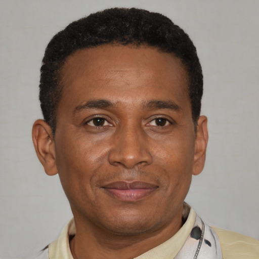 Joyful latino adult male with short  brown hair and brown eyes