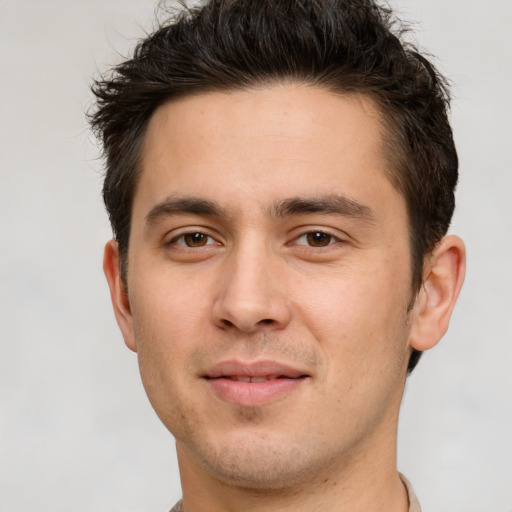 Joyful white young-adult male with short  brown hair and brown eyes