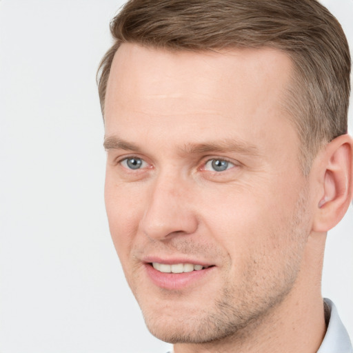 Joyful white adult male with short  brown hair and grey eyes