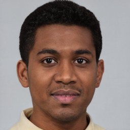 Joyful latino young-adult male with short  brown hair and brown eyes