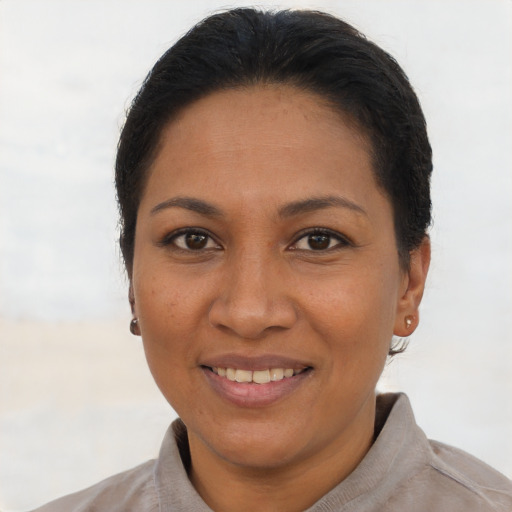 Joyful latino adult female with short  brown hair and brown eyes
