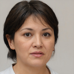 Joyful white adult female with medium  brown hair and brown eyes