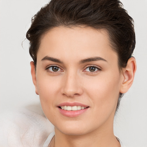 Joyful white young-adult female with short  brown hair and brown eyes