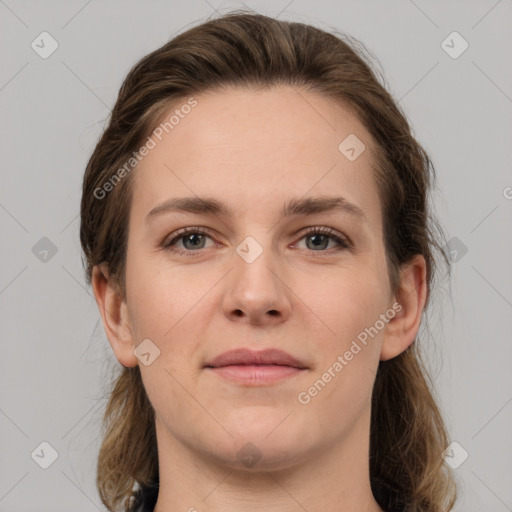 Joyful white young-adult female with medium  brown hair and grey eyes