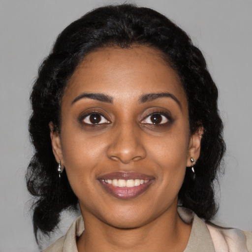 Joyful black young-adult female with medium  black hair and brown eyes