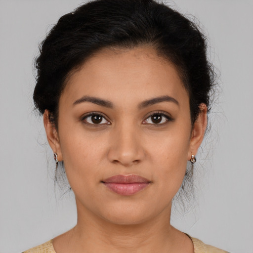 Joyful latino young-adult female with medium  brown hair and brown eyes