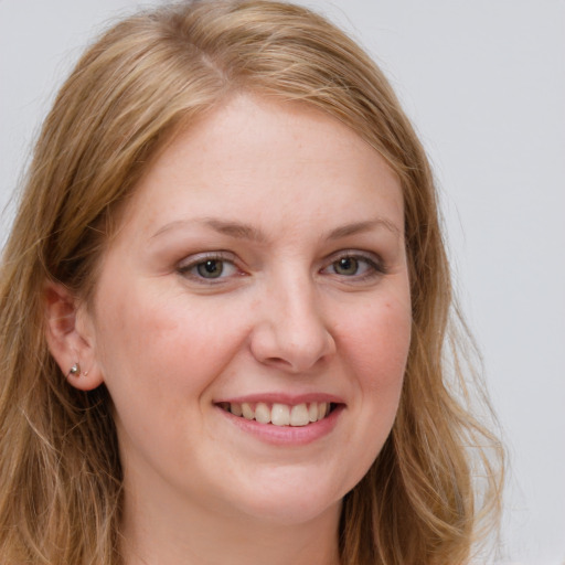 Joyful white young-adult female with long  brown hair and blue eyes