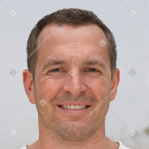 Joyful white adult male with short  brown hair and brown eyes