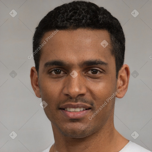 Joyful black young-adult male with short  black hair and brown eyes